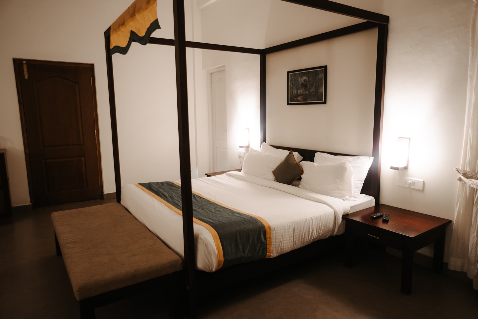 Four-poster bed by lamplight – Abad Brookside Lakkidi, Wayanad