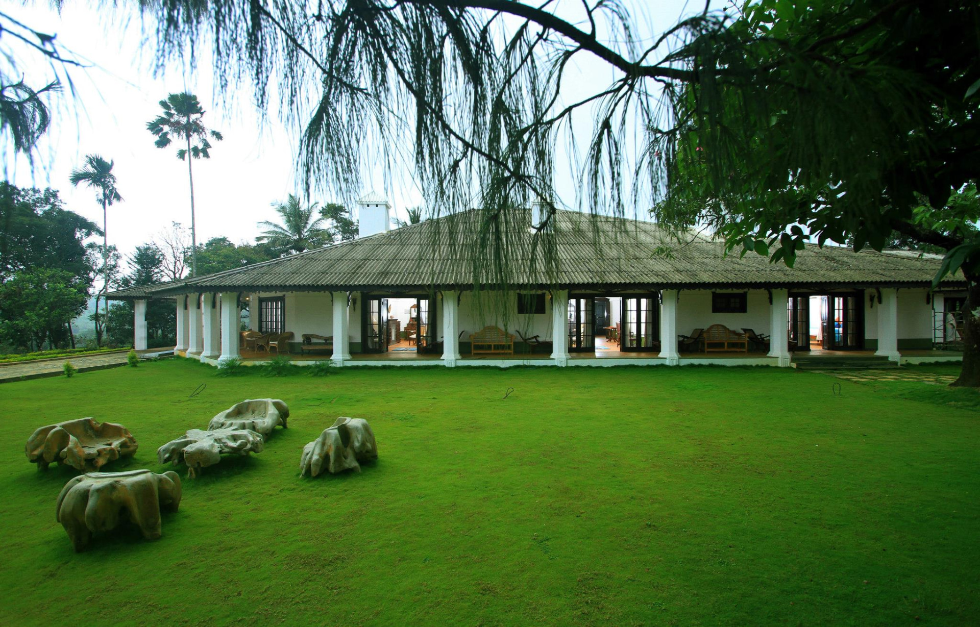 Heritage planter's bungalow with wide verandah and sculpted lawn