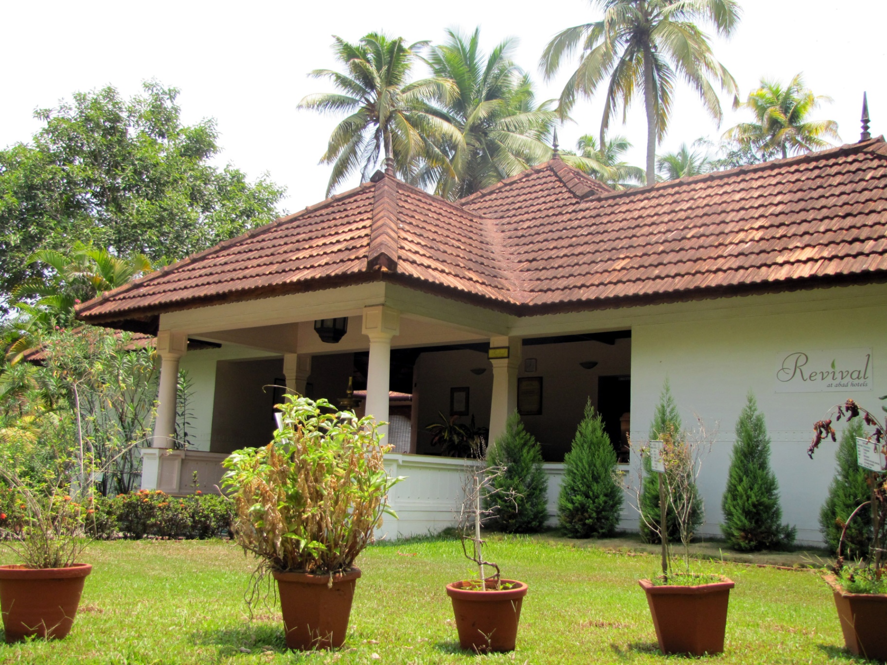 Revival Ayurvedic Spa building with terracotta tile roof set in tropical gardens