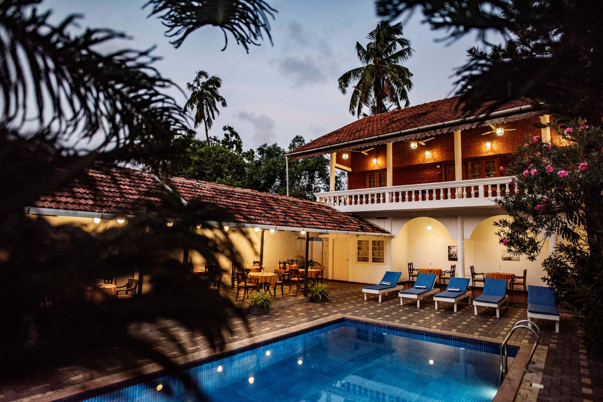 Courtyard pool and loungers at dusk