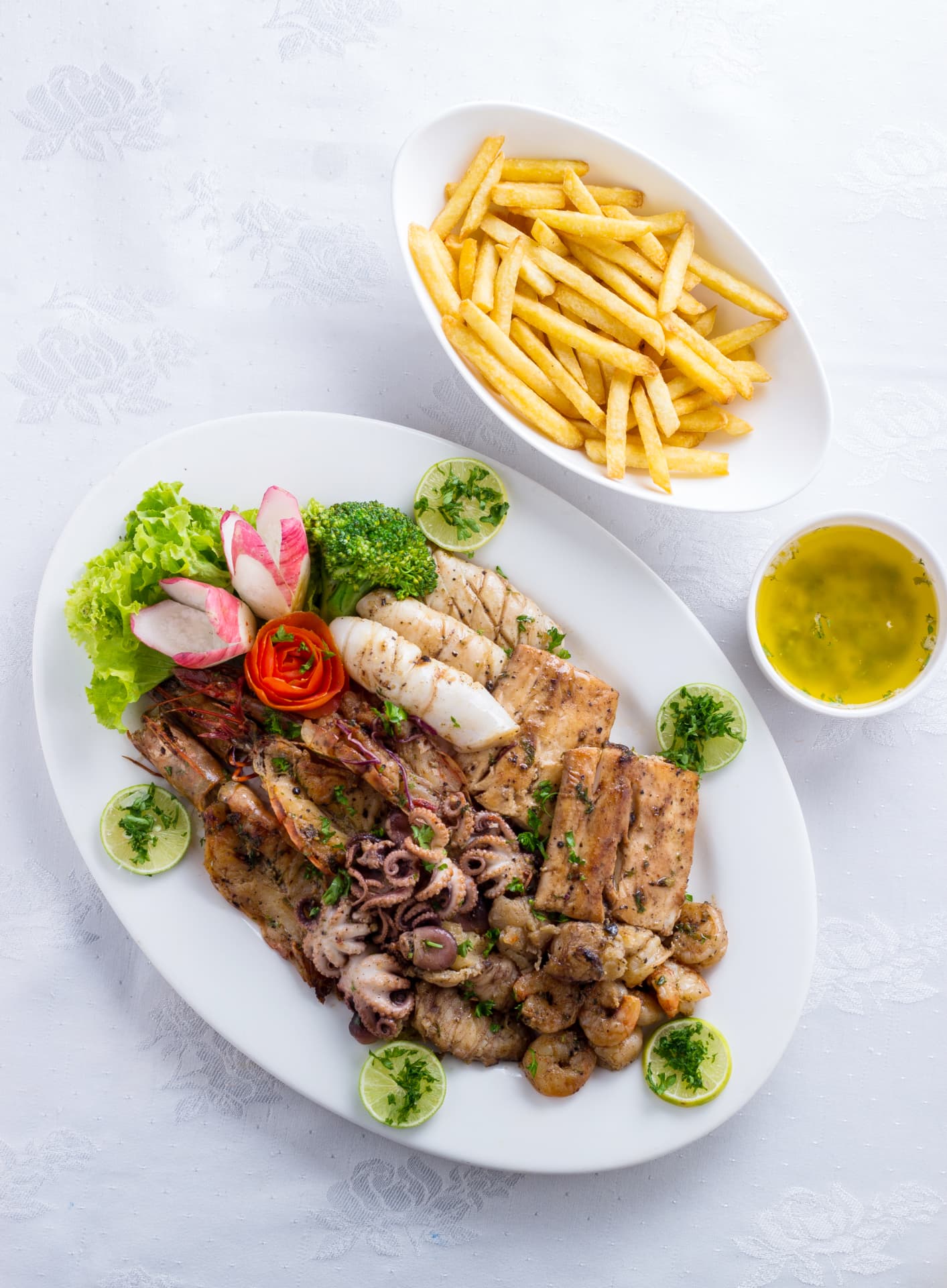 Grilled seafood platter with calamari, prawns and fries