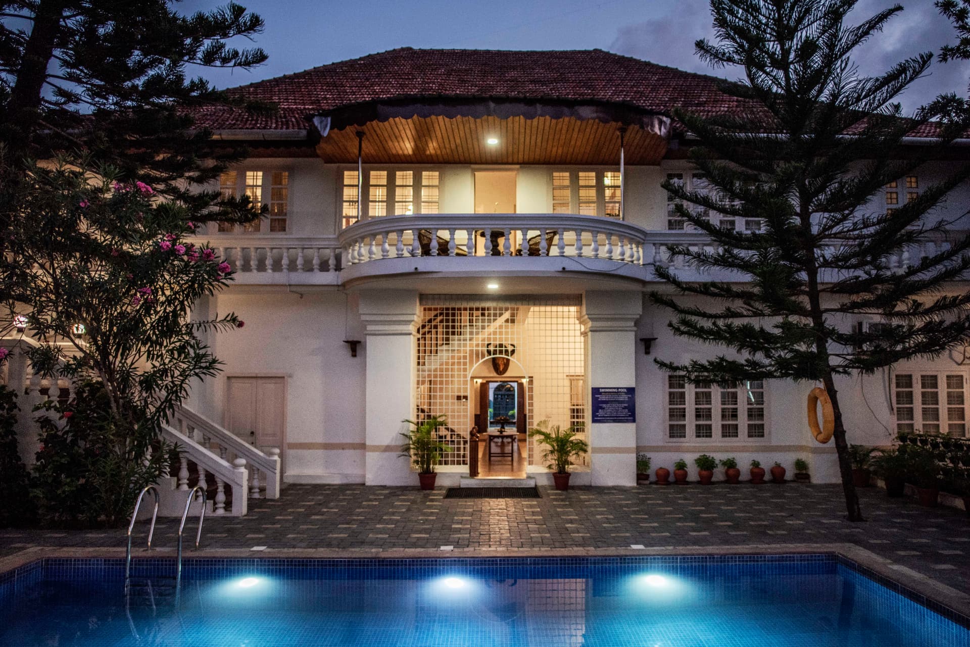 Illuminated swimming pool before the heritage facade