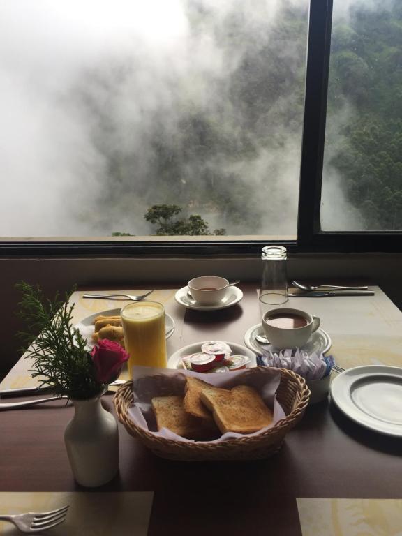 Breakfast beside a misty window at Abad Copper Castle