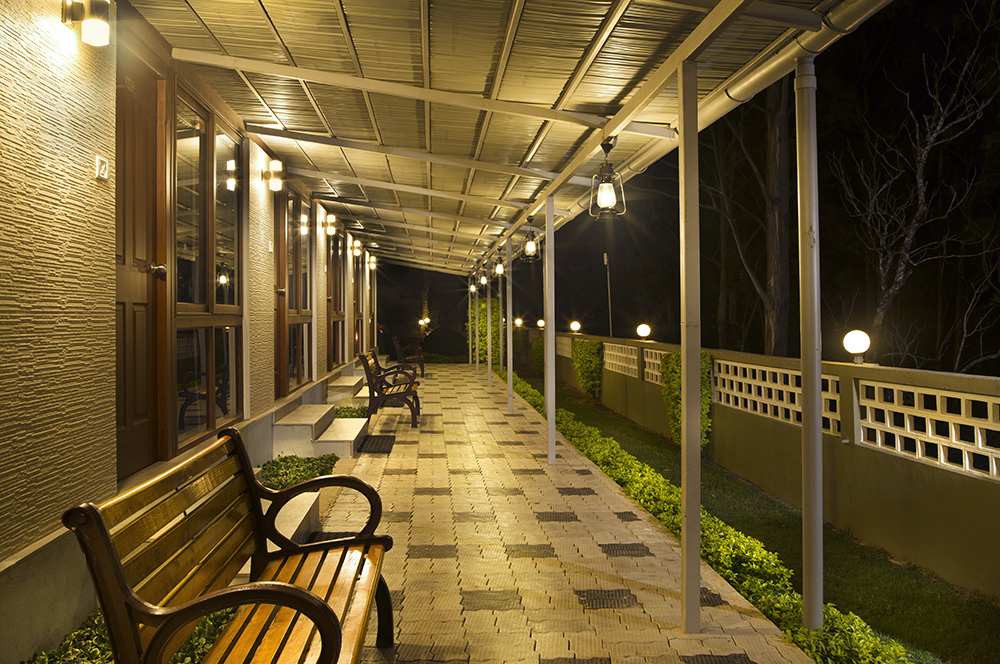 Lantern-lit verandah walkway at Abad Copper Castle at night