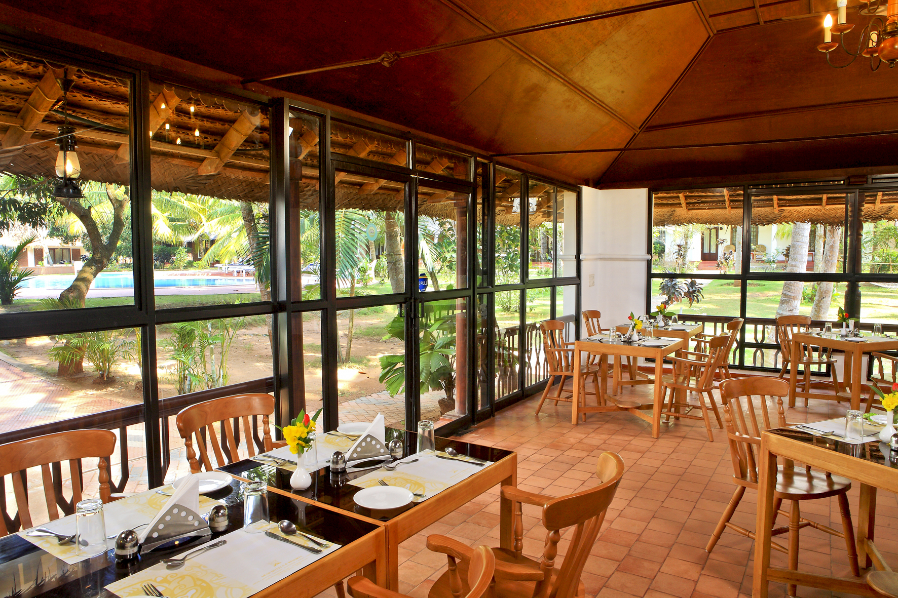 Garden-view restaurant with timber furniture and glazed walls