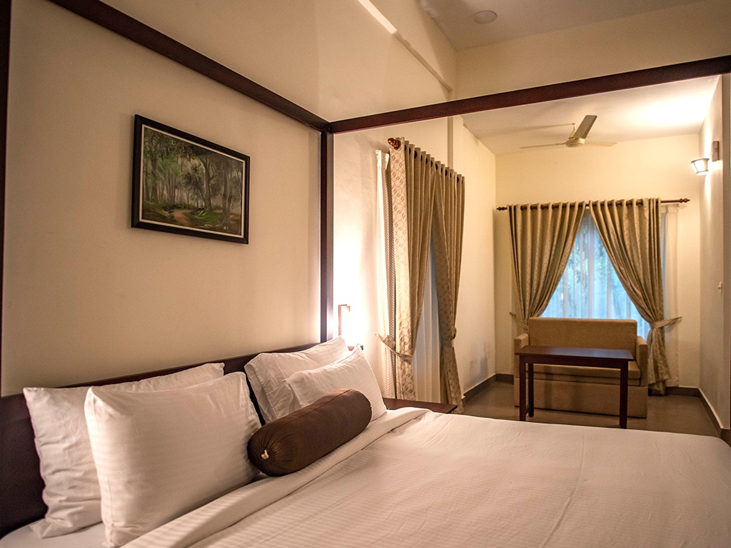 Bedroom and lounge – Abad Brookside Lakkidi, Wayanad