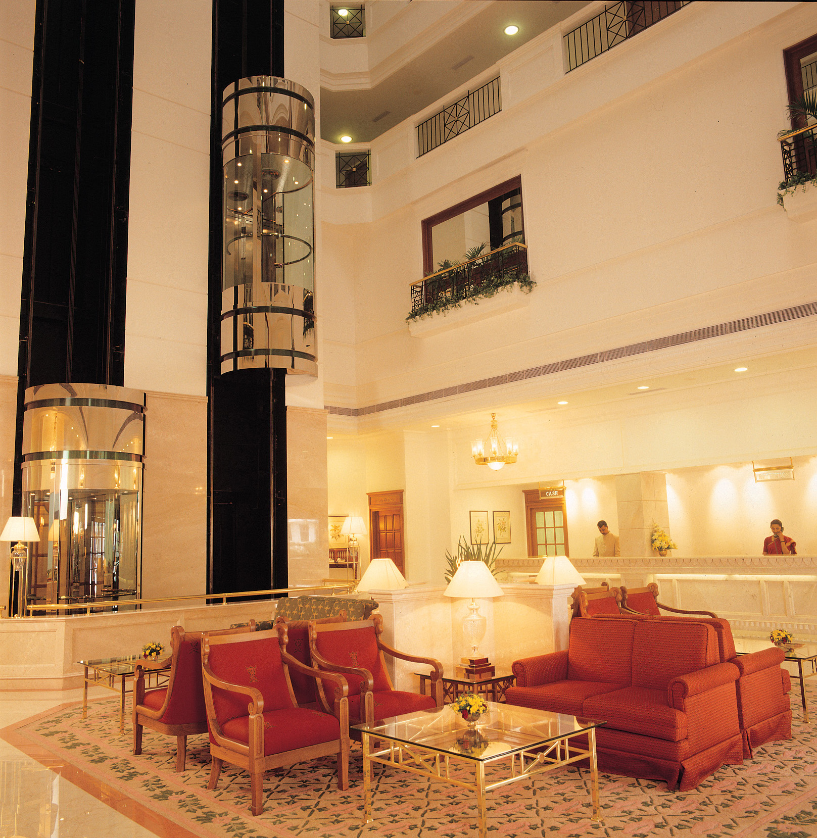 Atrium lobby with glass capsule lifts and lounge seating