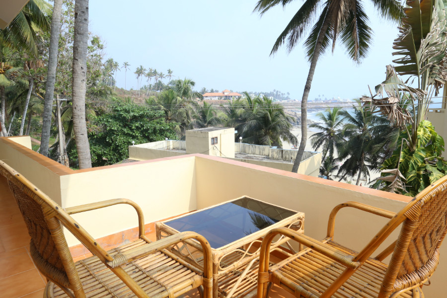 Private balcony with cane seating and sea views at Abad Serviced Villas