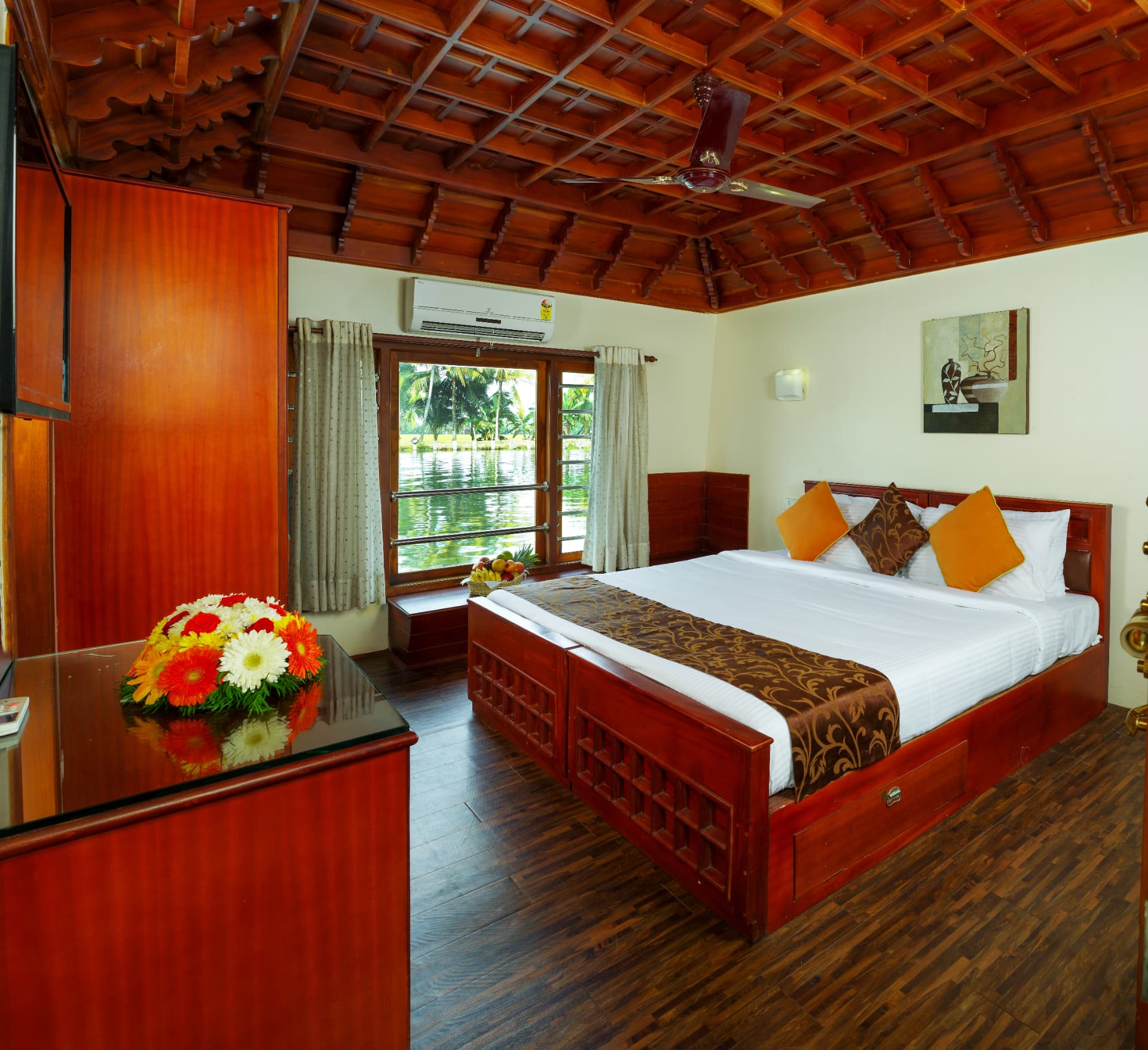 Houseboat bedroom with carved timber ceiling, king bed and backwater-facing window