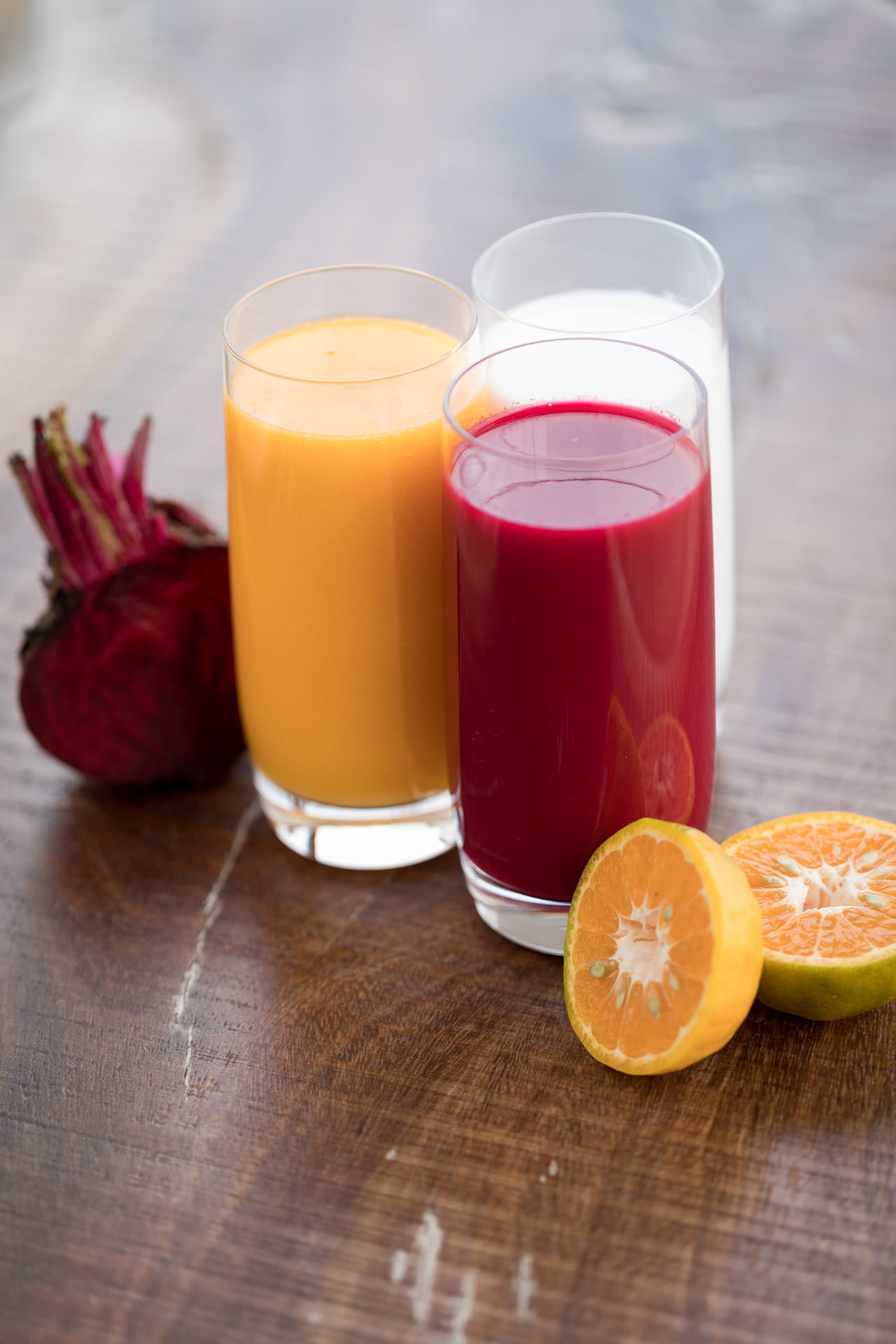 Three glasses of freshly pressed juices with beetroot and citrus at Prakriti Shakti, Kerala