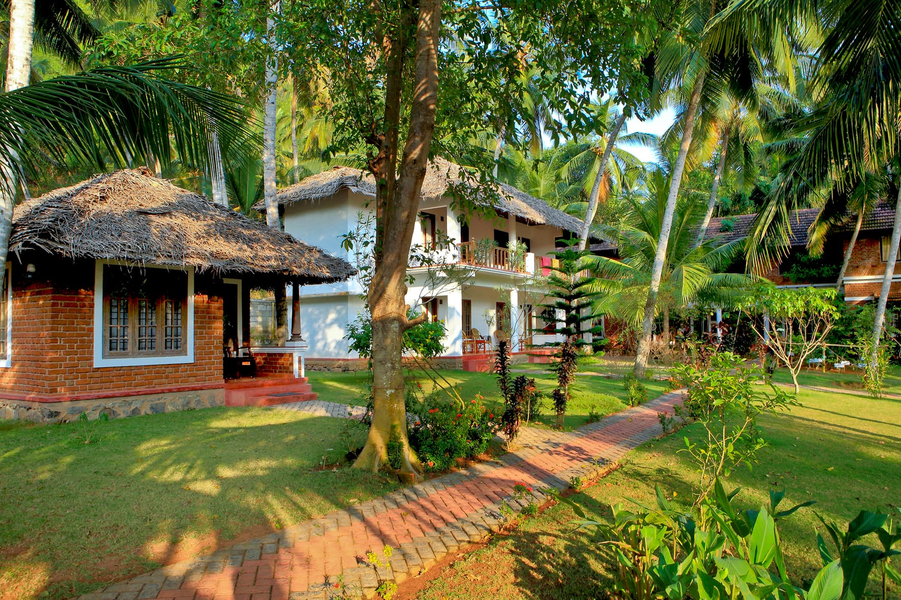 Brick garden cottage with thatched roof at Abad Harmonia