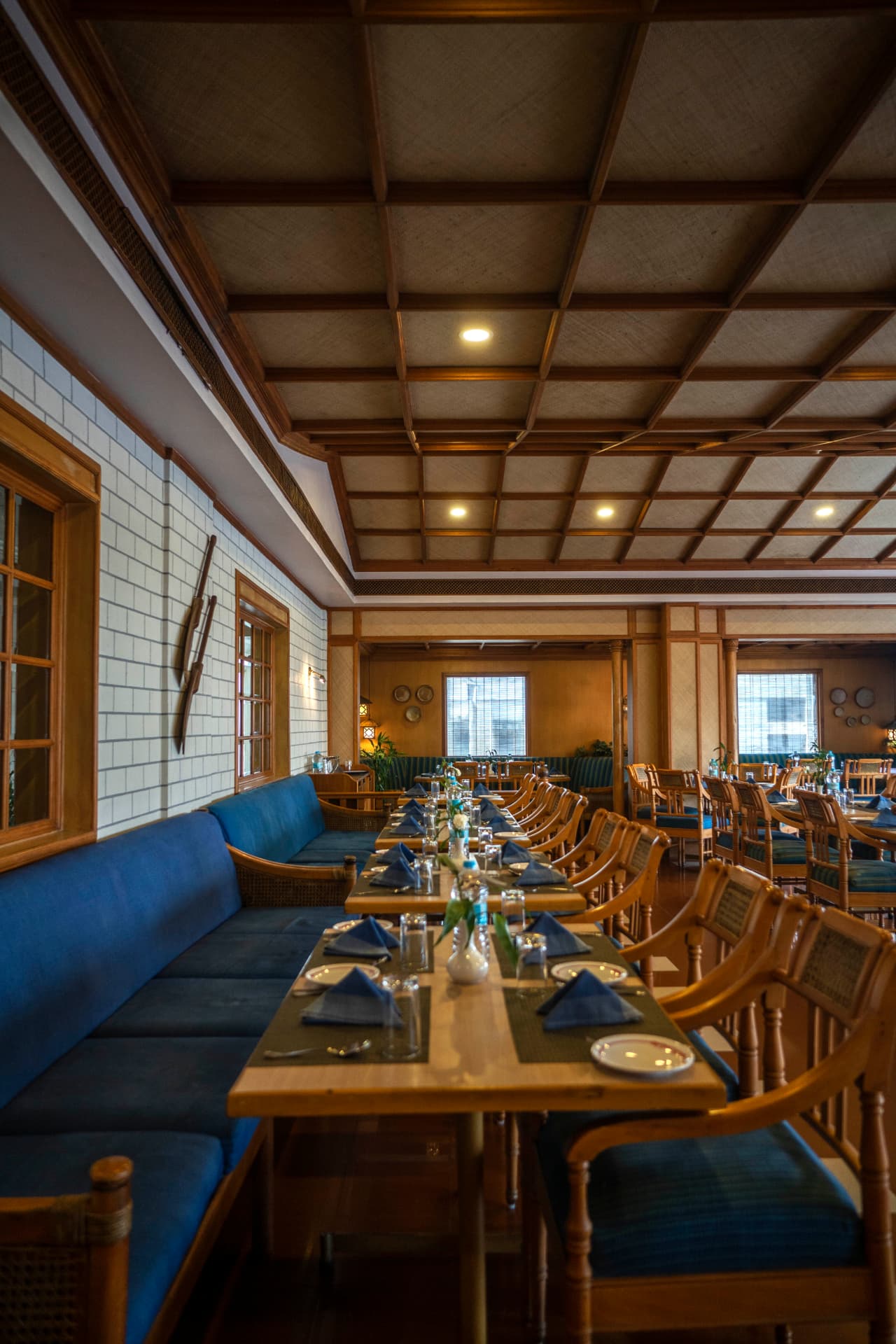 Cafe Canopy with blue booth seating and long communal table