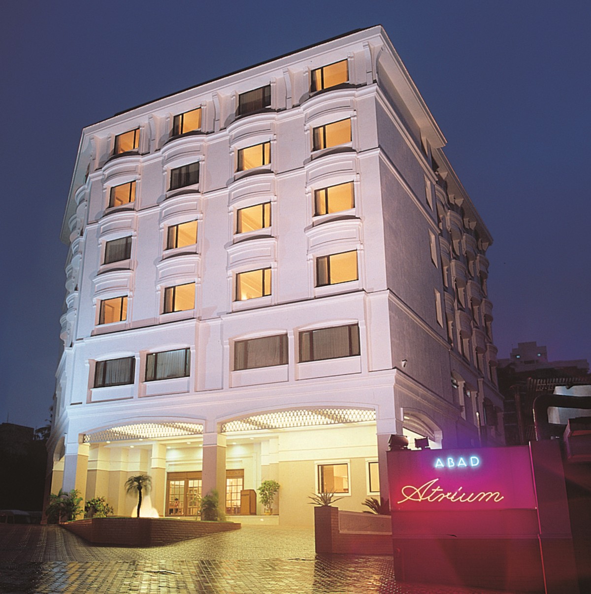 Illuminated exterior of Abad Atrium on MG Road, Kochi at dusk