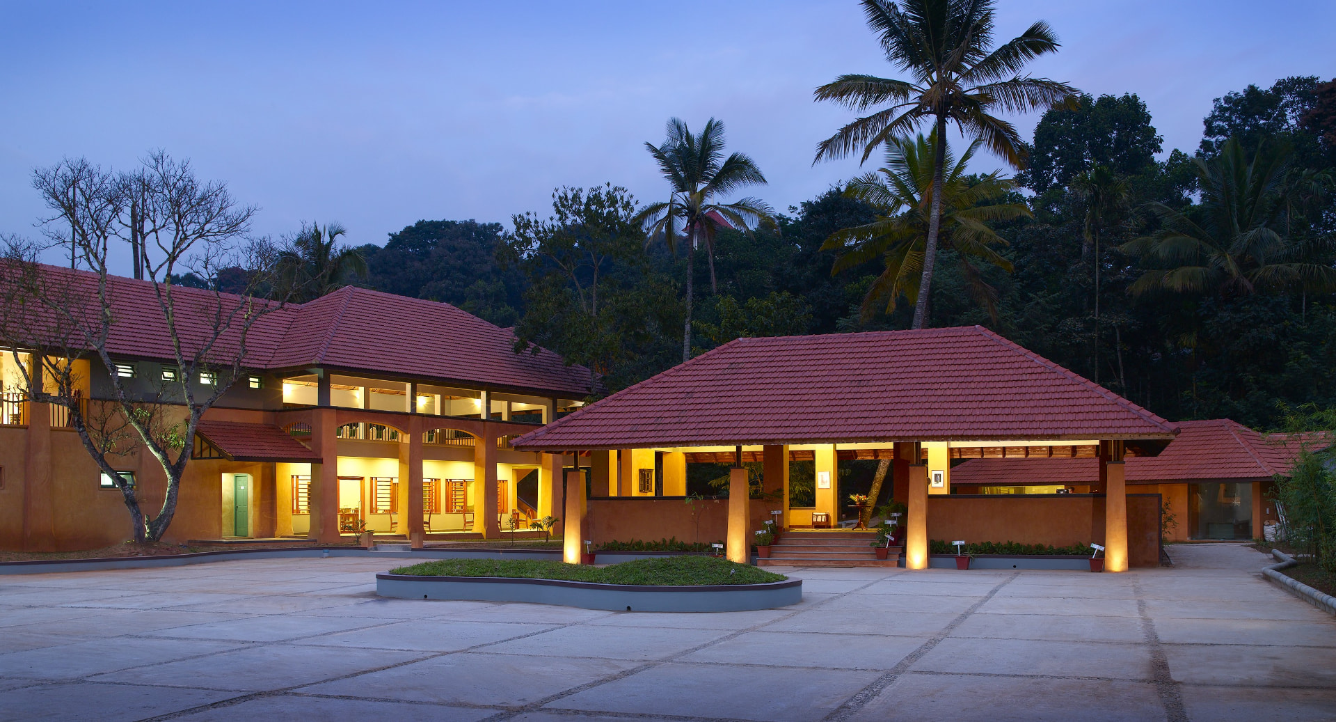 Resort facade at dusk – Abad Green Forest, Thekkady
