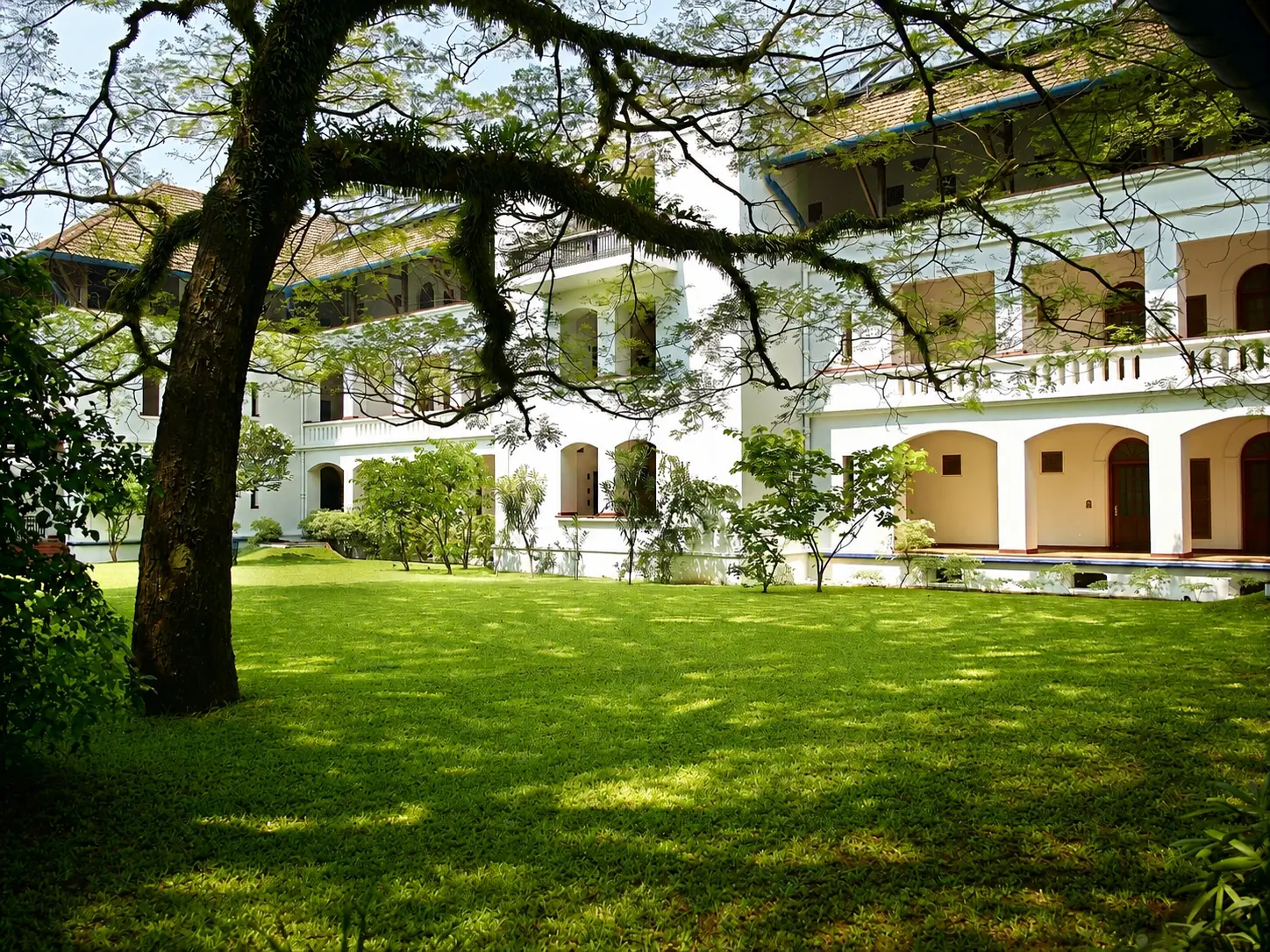 Brunton Boatyard heritage hotel and lawn beside the harbour in Fort Kochi