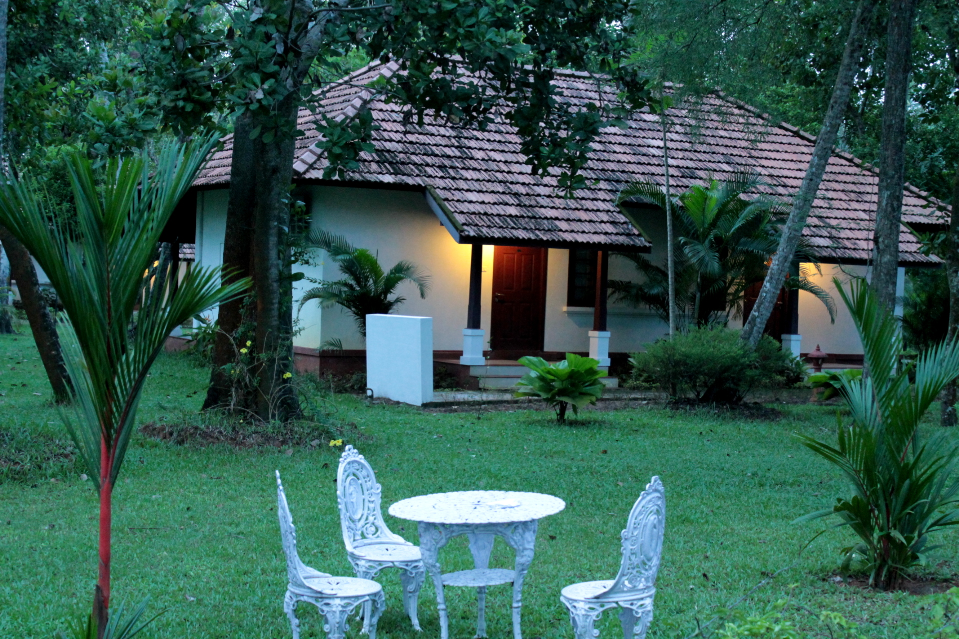 Cottage exterior at dusk with private seating area
