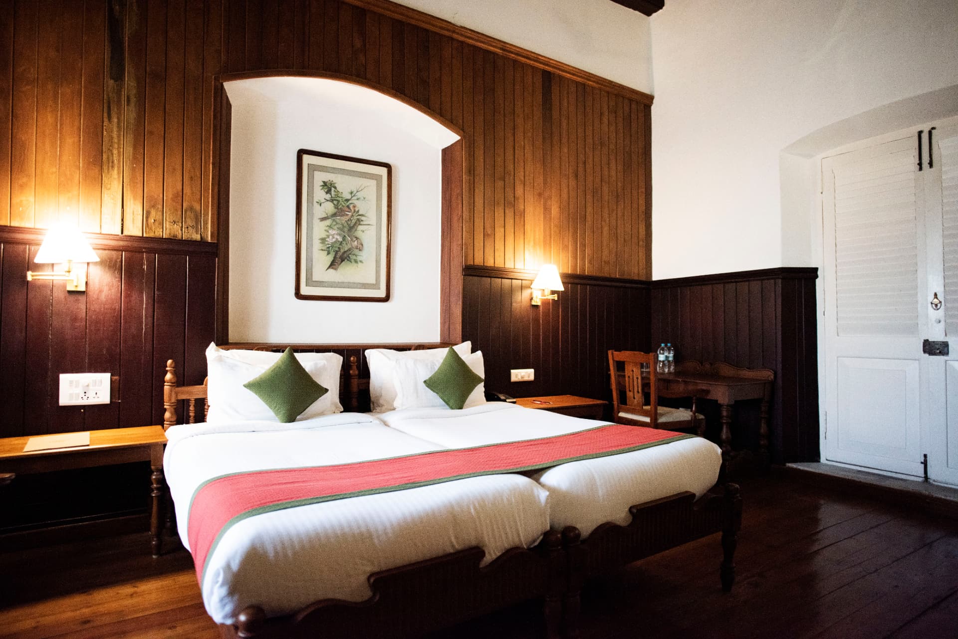 Teak-panelled Heritage Boutique room with arched headboard niche