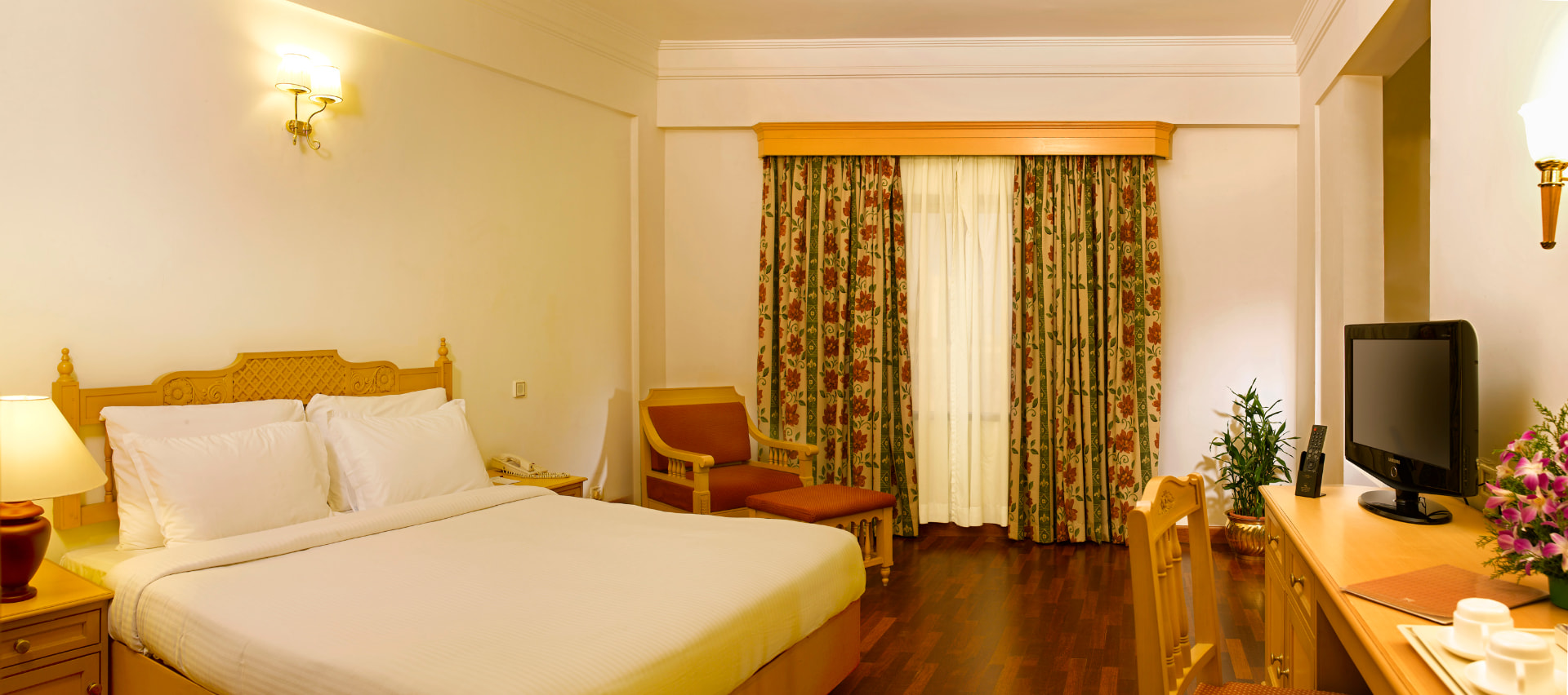 Suite bedroom with king-size bed and writing desk