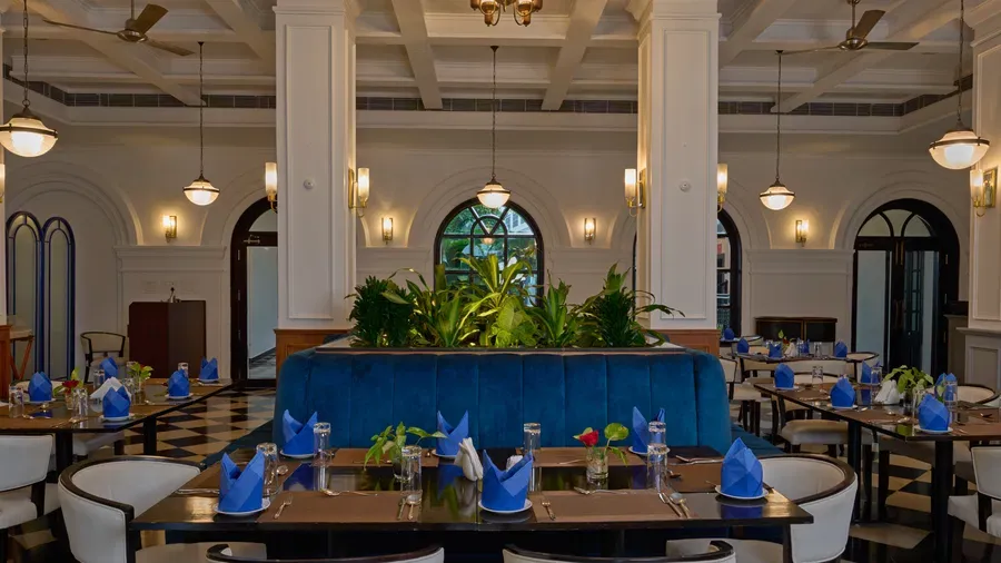 Café Rendezvous dining room with blue banquette and arched windows