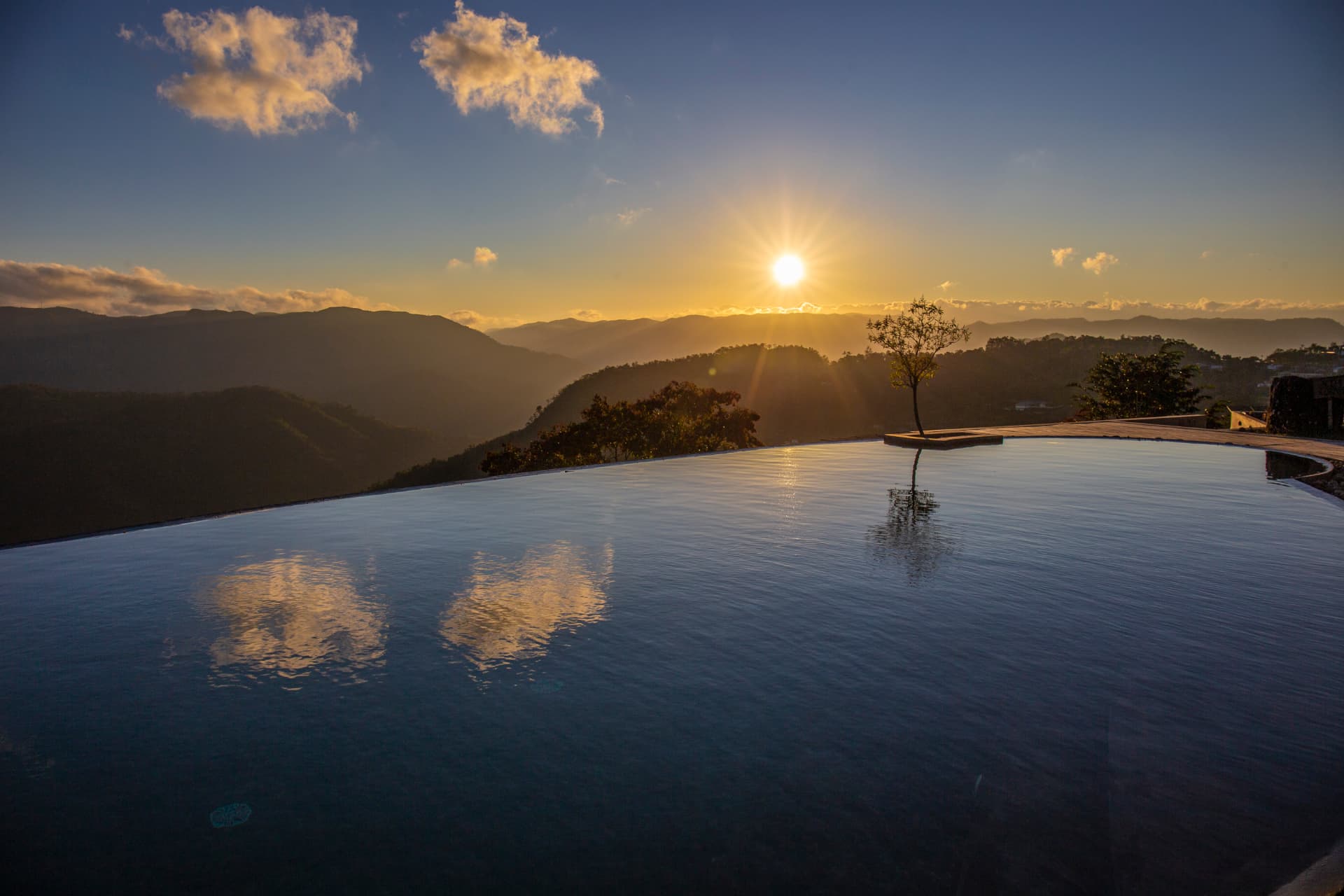 Sunrise over the Western Ghats seen across the infinity pool at Prakriti Shakti, Panchalimedu