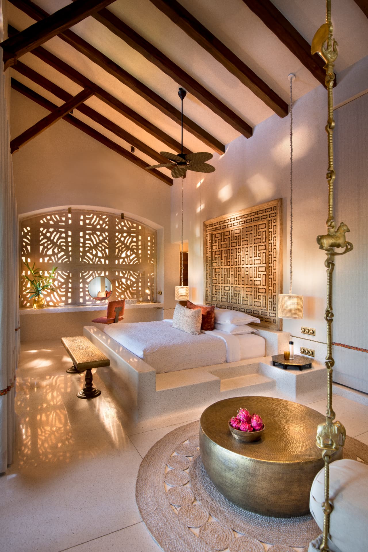 Kothi bedroom beneath timber rafters