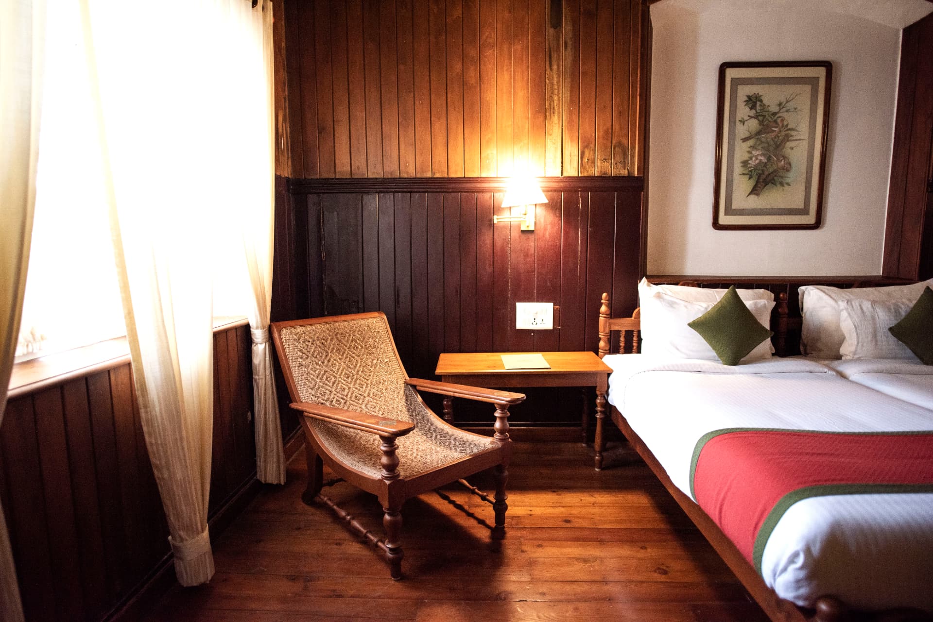 Boutique room with woven planter's chair and writing table