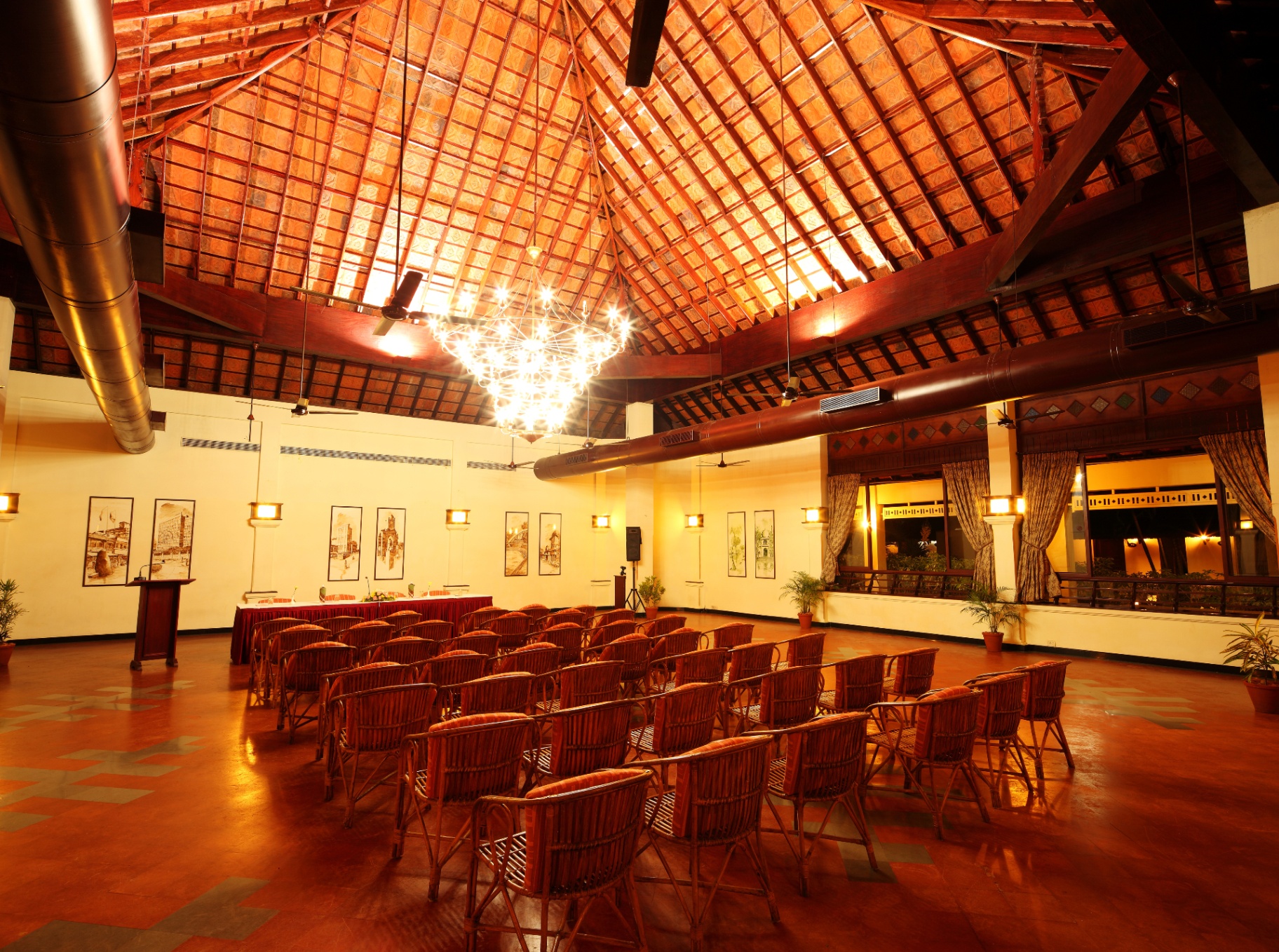 Vedhi banquet hall in theatre seating with a soaring tiled Kerala roof