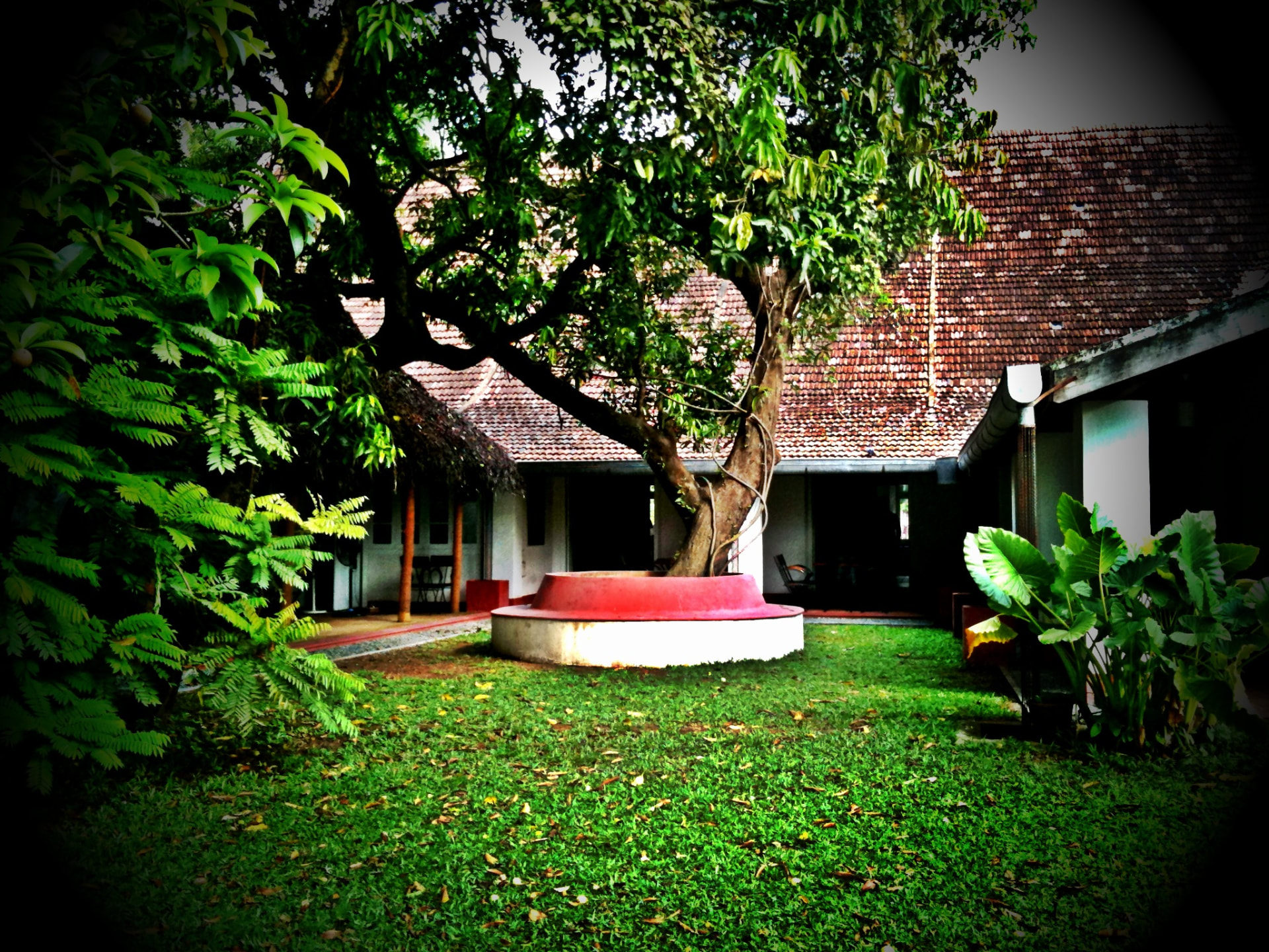 Courtyard and tiled roofs of David Hall heritage art gallery and café in Fort Kochi