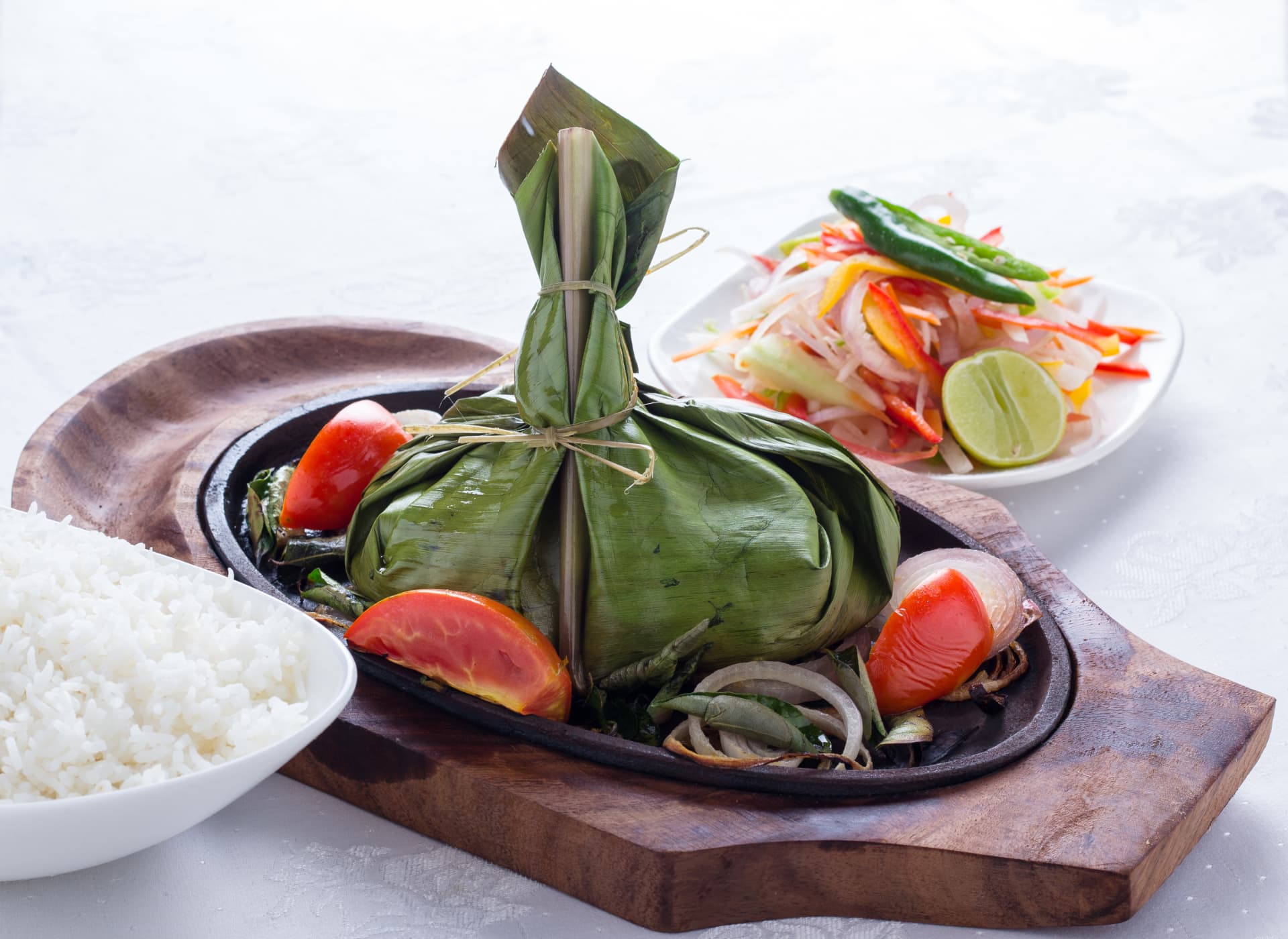 Banana-leaf fish pollichathu served sizzling with rice