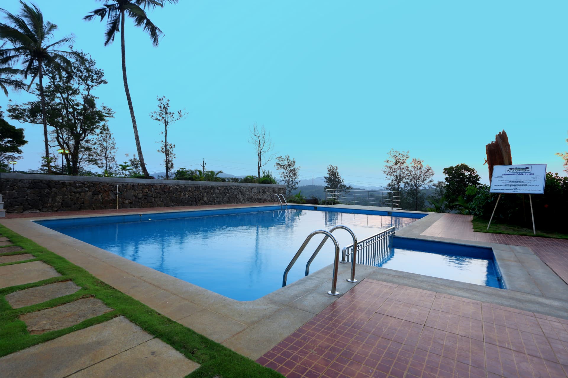 Estate swimming pool with hill views at dawn