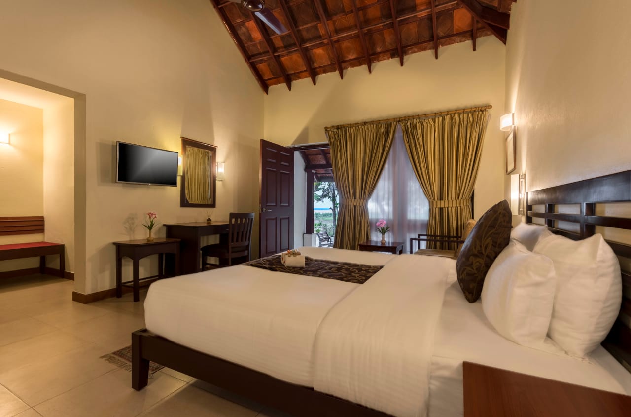 Spacious cottage bedroom with traditional Kerala roof detailing