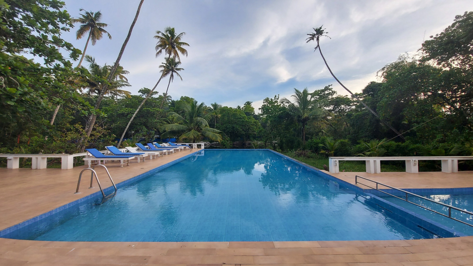 Palm-fringed swimming pool at Abad Turtle Beach