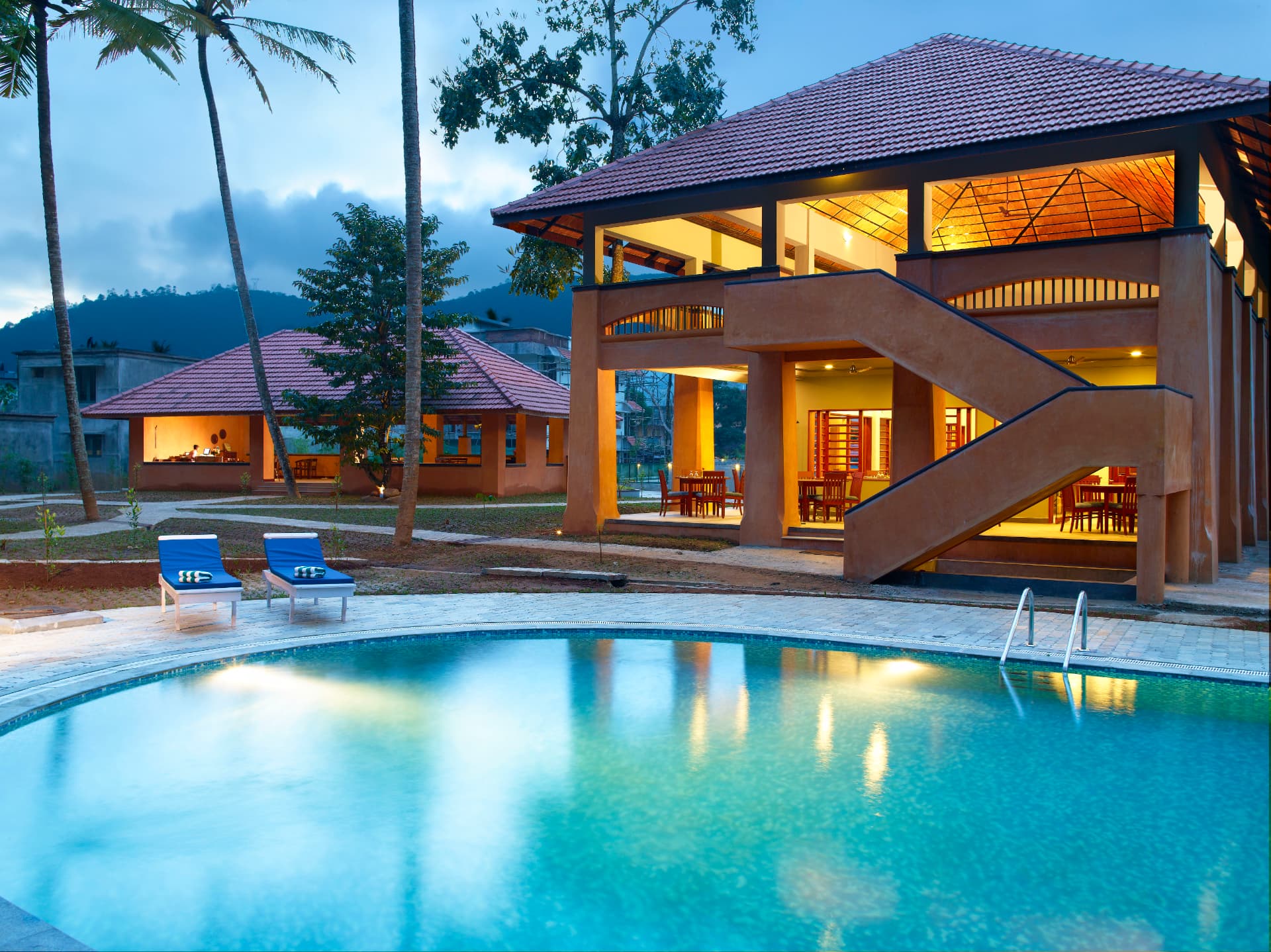 Poolside pavilion at dusk – Abad Green Forest, Thekkady