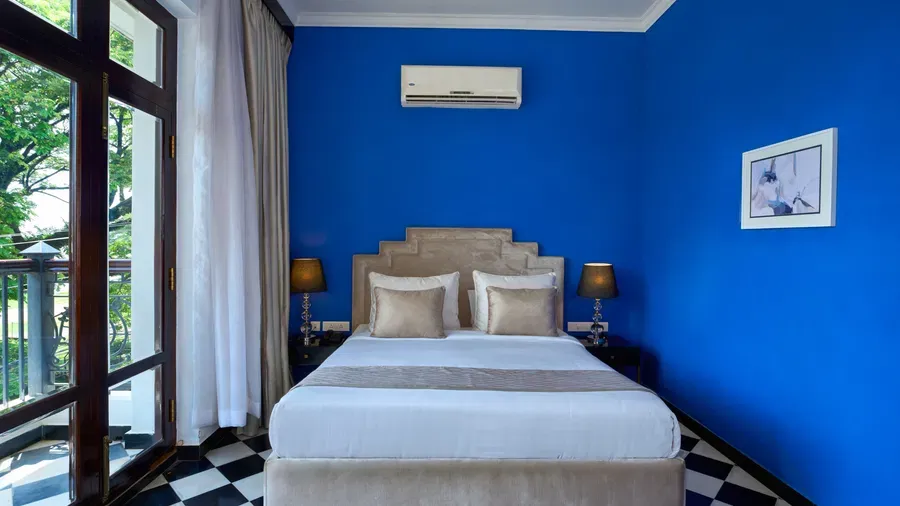 Heritage room with king-size bed and chequered tiled floor